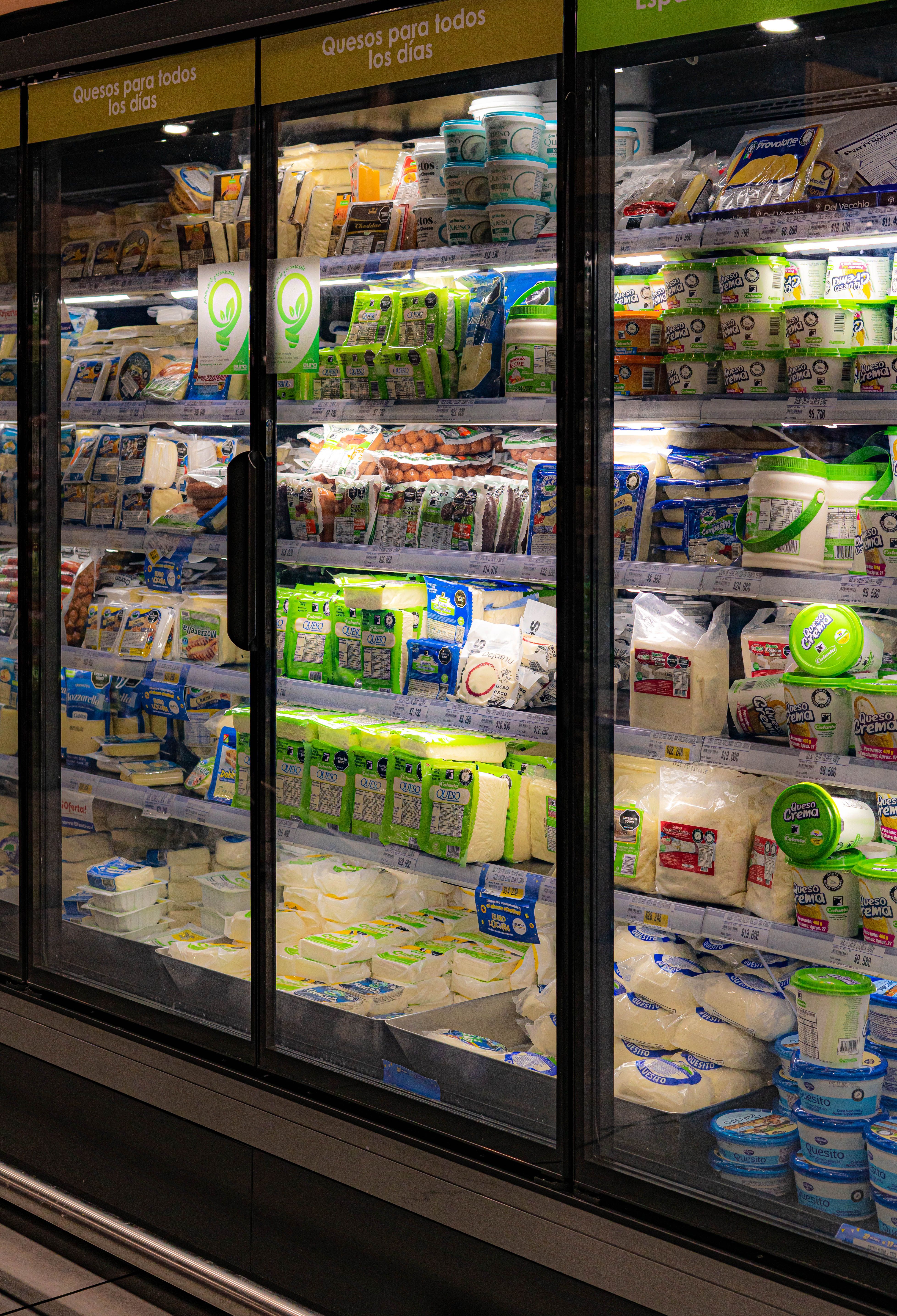 Refrigerated cold storage display cases stocked with dairy products